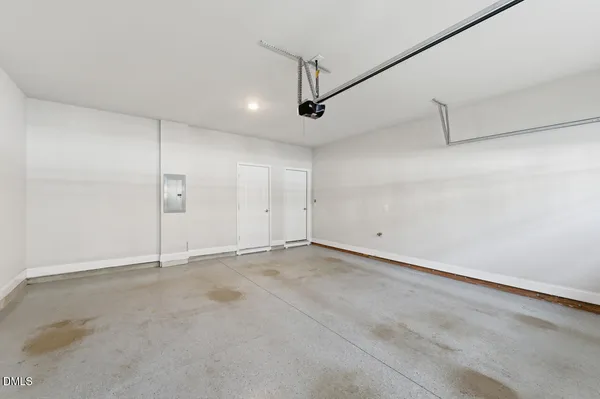 an empty room with ceiling fan and windows