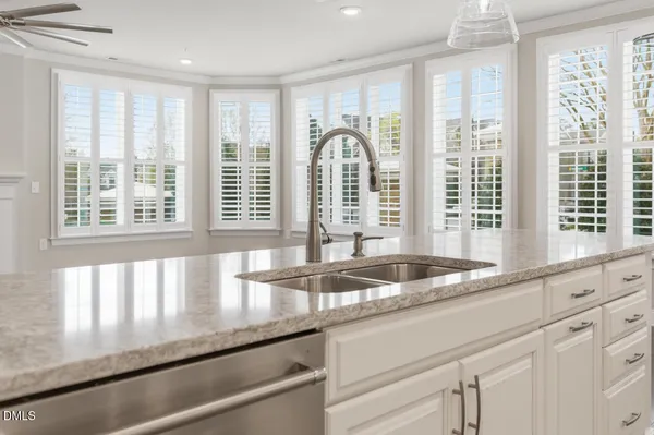 a kitchen with a sink and large window
