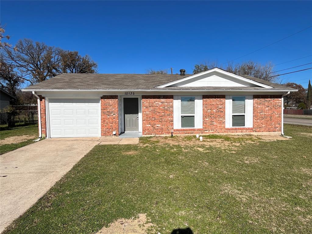 Single story home featuring concrete driveway, a front lawn, and brick siding