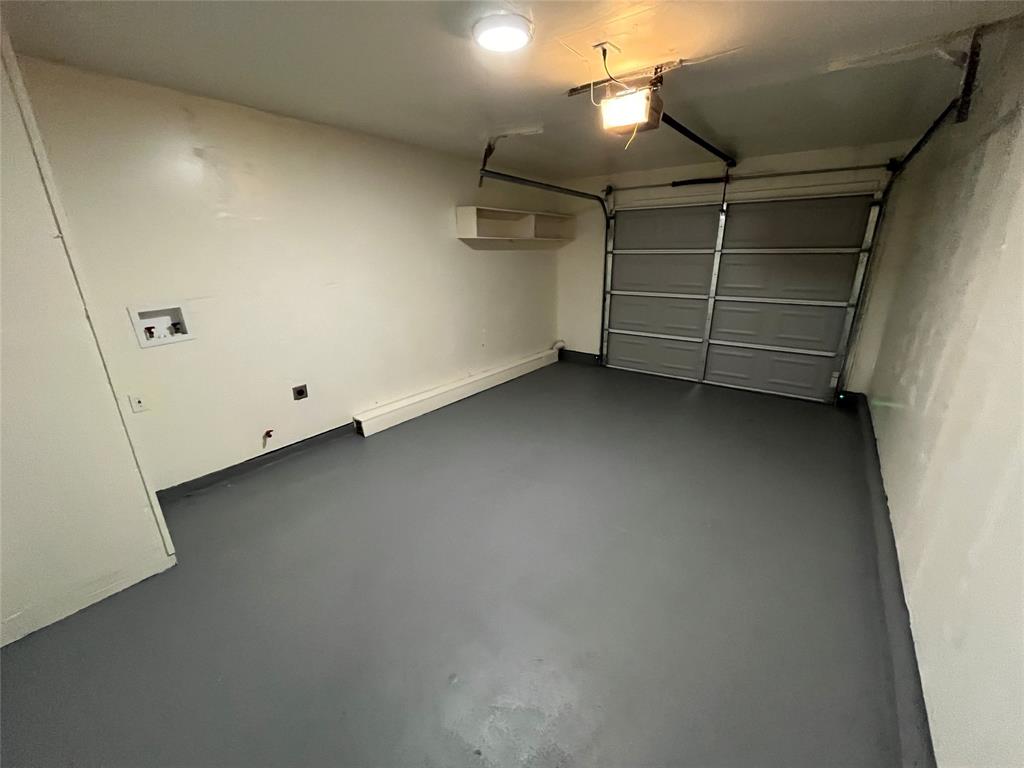 10135 Kittyhawk Lane Dallas, TX 75217 - Photo 14 of 17 Garage featuring a garage door opener