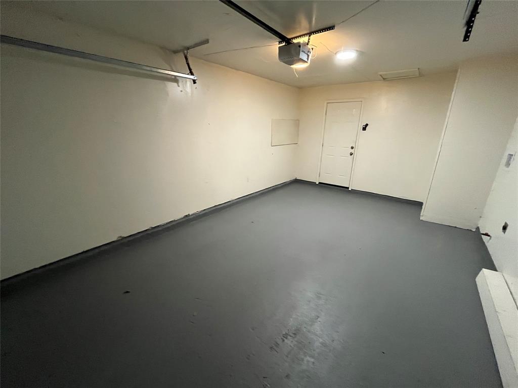 10135 Kittyhawk Lane Dallas, TX 75217 - Photo 15 of 17 Garage featuring a garage door opener