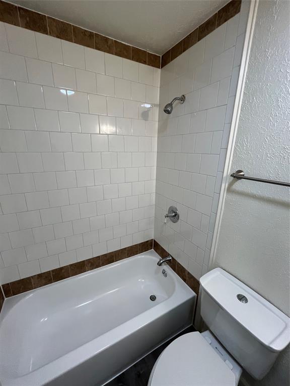 10135 Kittyhawk Lane Dallas, TX 75217 - Photo 6 of 17 Full bath with a textured wall and shower combination