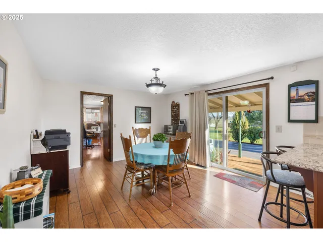 a dining room with furniture and wooden floor