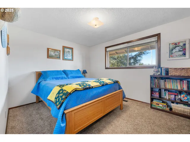 a bedroom with a bed and a painting on the wall