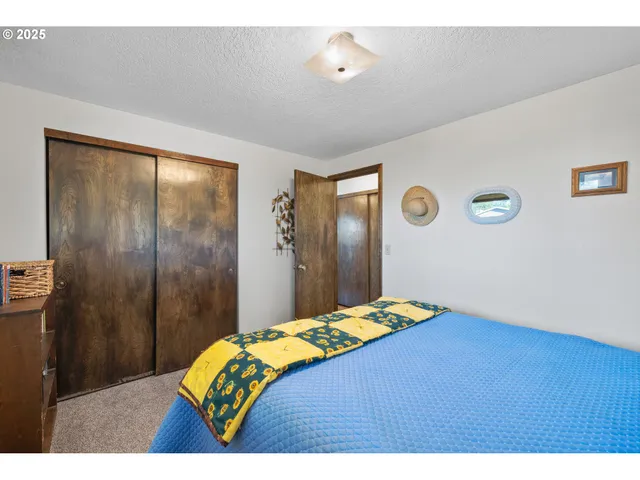 a bathroom with a granite countertop sink a toilet and a mirror
