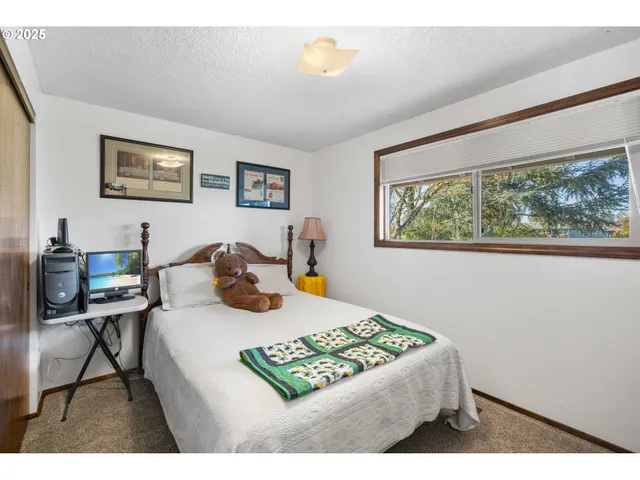 a bed room with a bed and a window