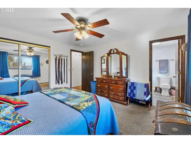 a bathroom with a granite countertop toilet sink and mirror