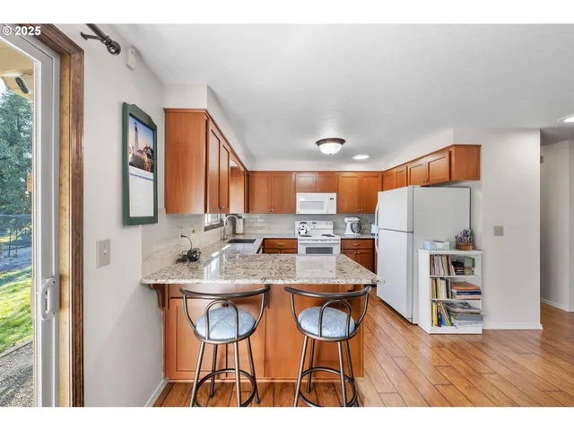 a kitchen with granite countertop a sink stainless steel appliances and cabinets