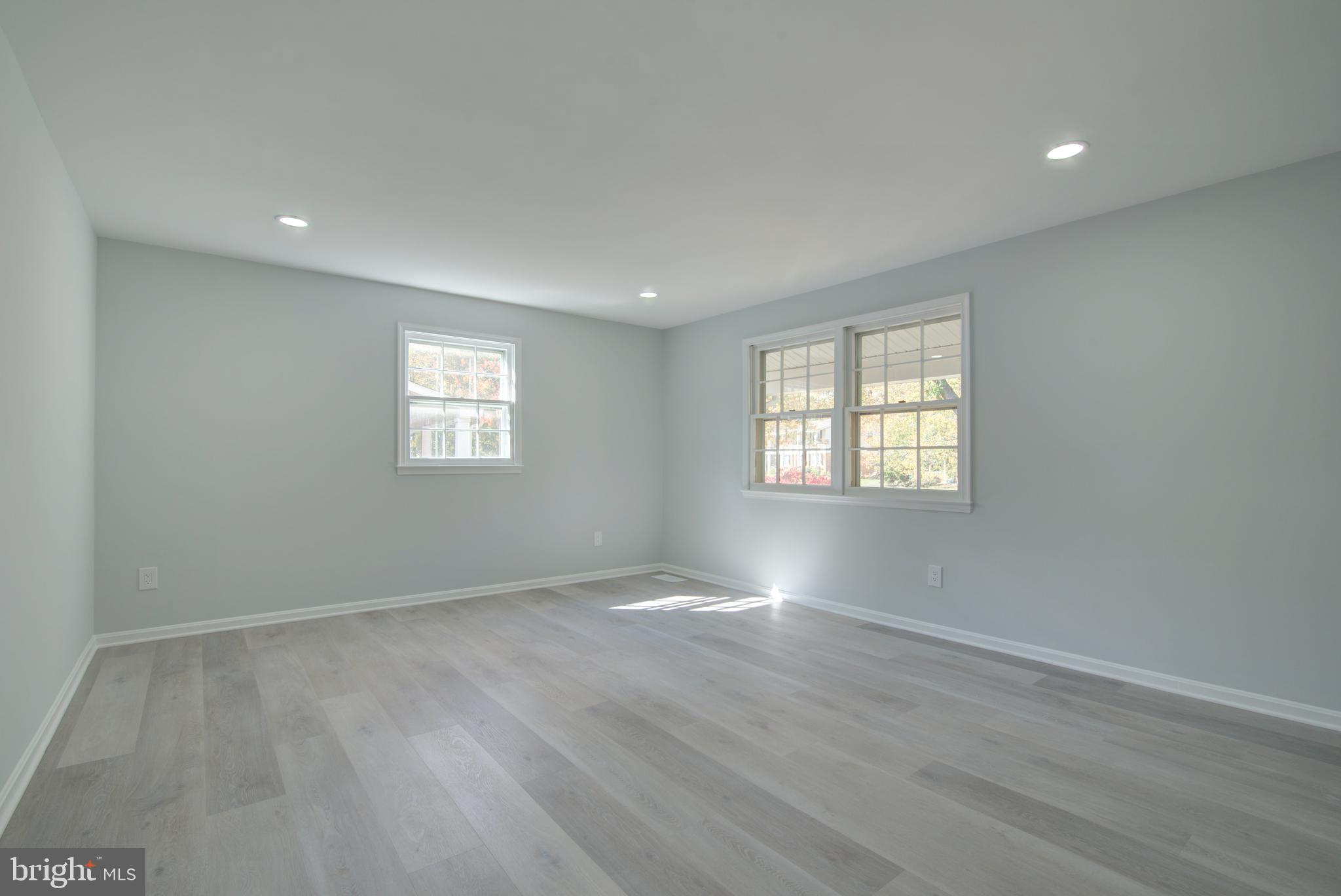 7411 Reservation Drive Springfield, VA 22153 - Photo 13 of 30 an empty room with wooden floor and windows
