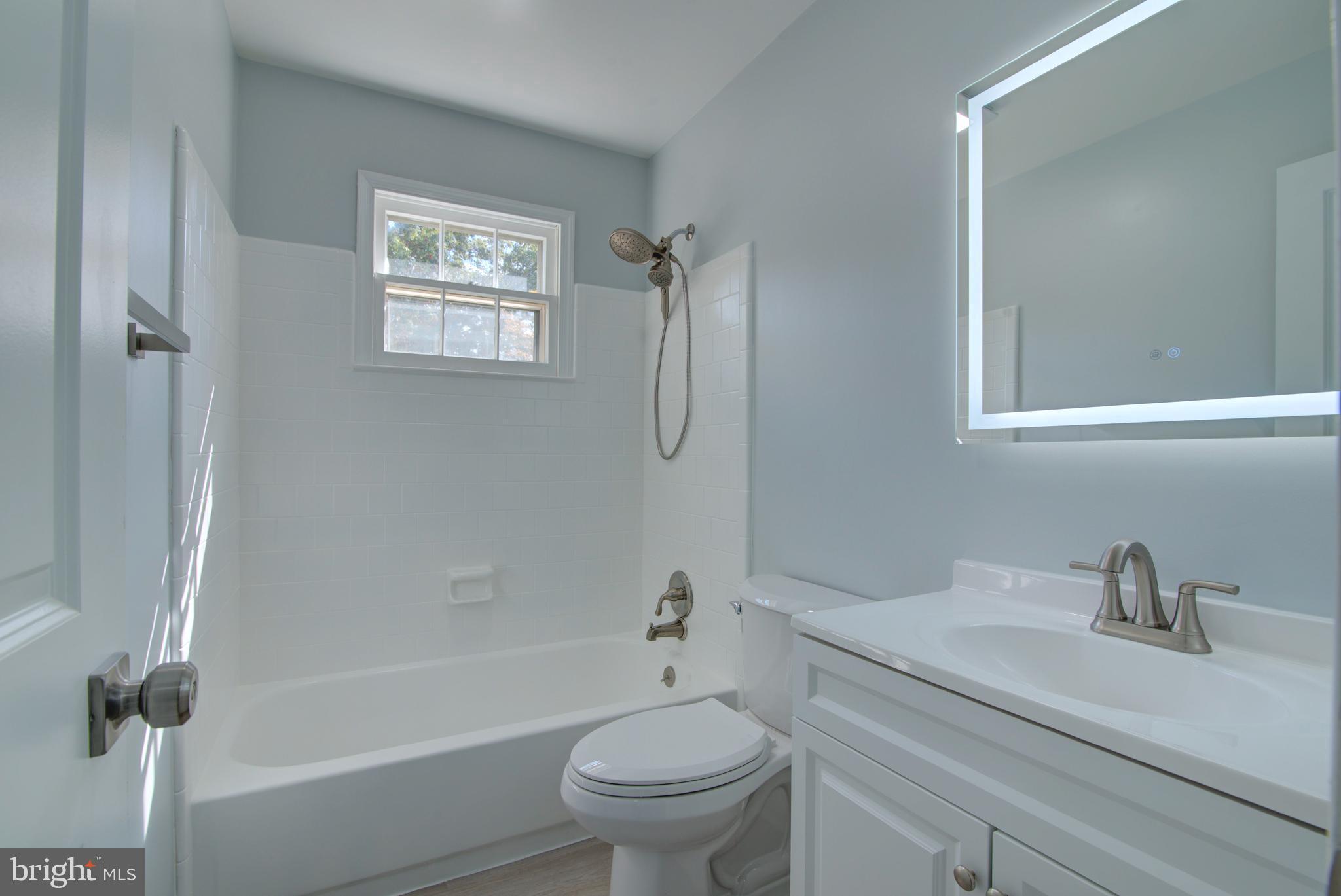 7411 Reservation Drive Springfield, VA 22153 - Photo 16 of 30 a bathroom with a sink a toilet and a tub