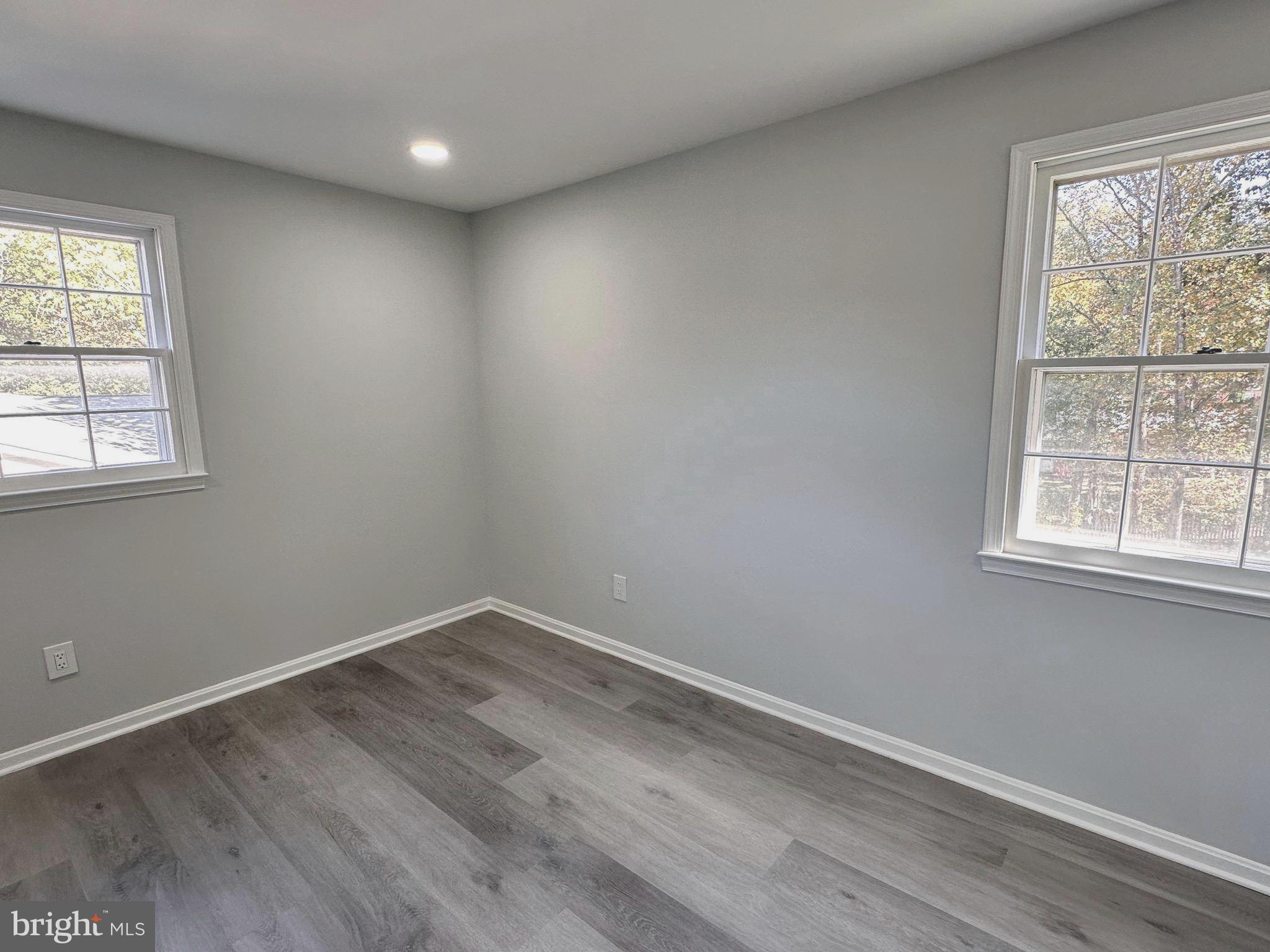 7411 Reservation Drive Springfield, VA 22153 - Photo 18 of 30 an empty room with wooden floor and windows