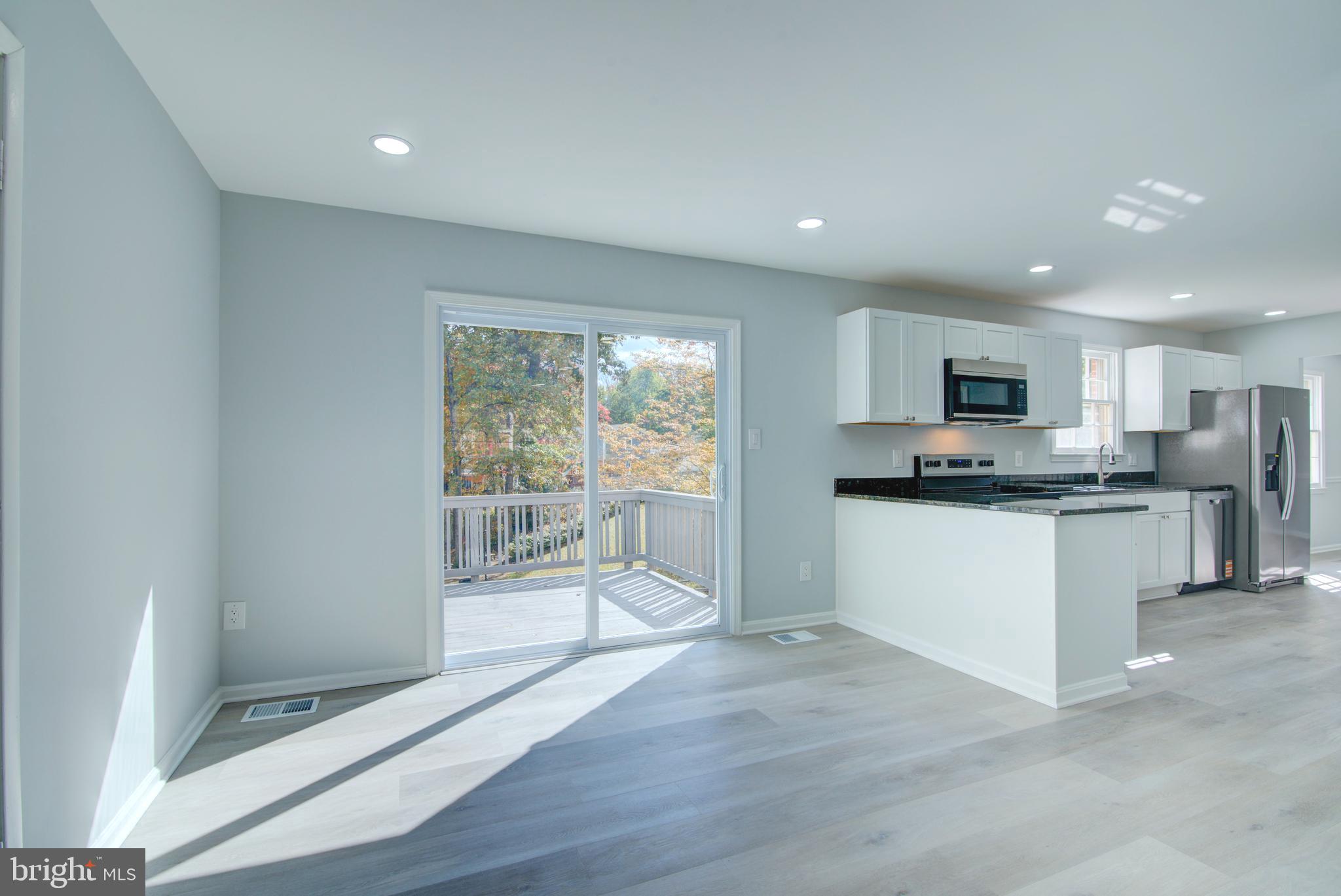 7411 Reservation Drive Springfield, VA 22153 - Photo 5 of 30 a kitchen with stainless steel appliances granite countertop a refrigerator sink and white cabinets