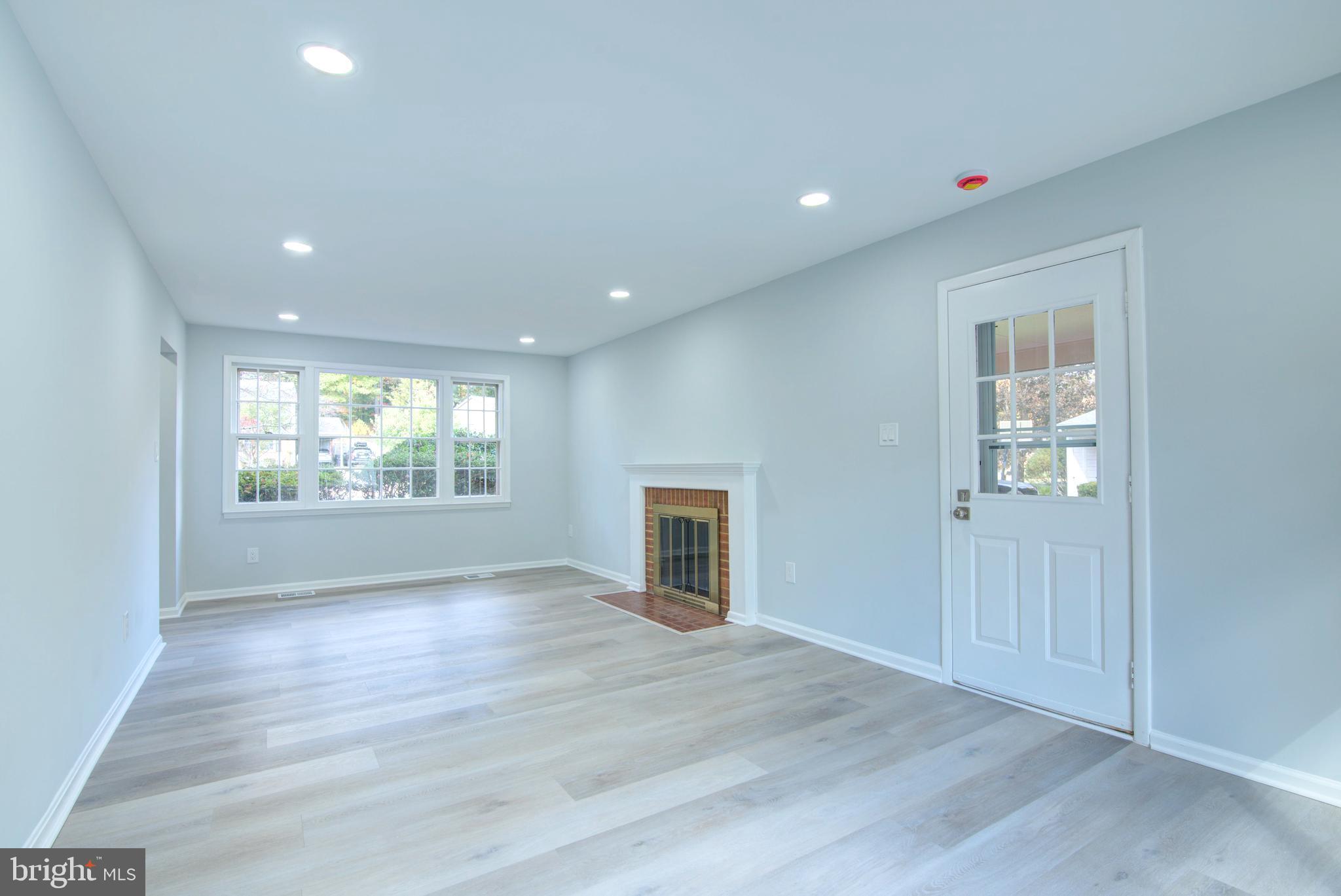 7411 Reservation Drive Springfield, VA 22153 - Photo 7 of 30 an empty room with wooden floor and windows