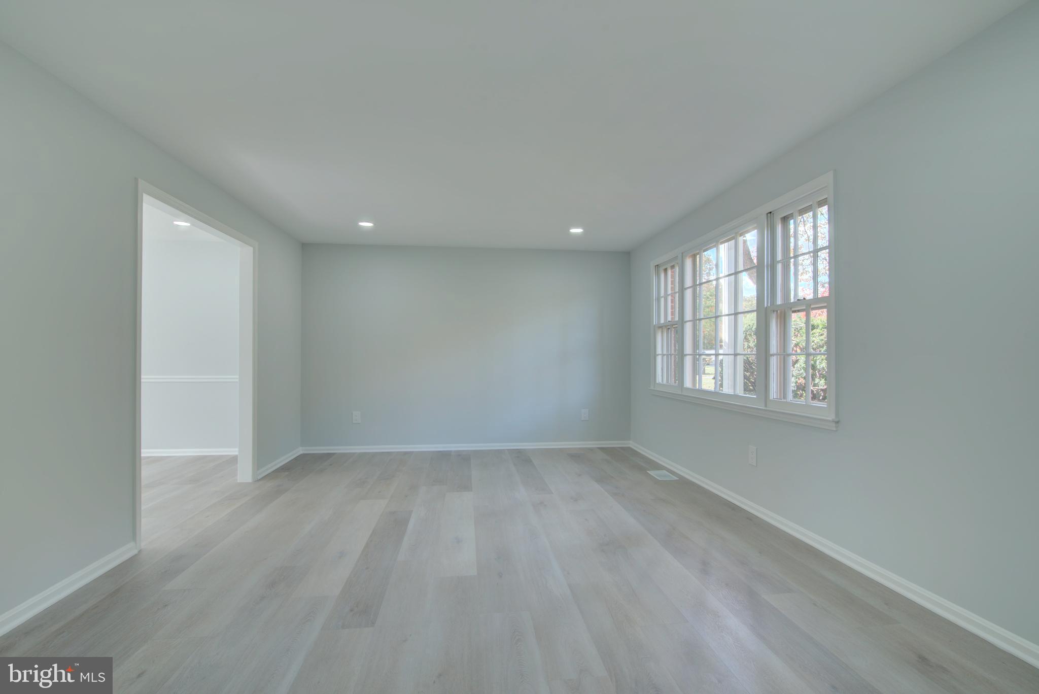 7411 Reservation Drive Springfield, VA 22153 - Photo 9 of 30 an empty room with wooden floor and windows