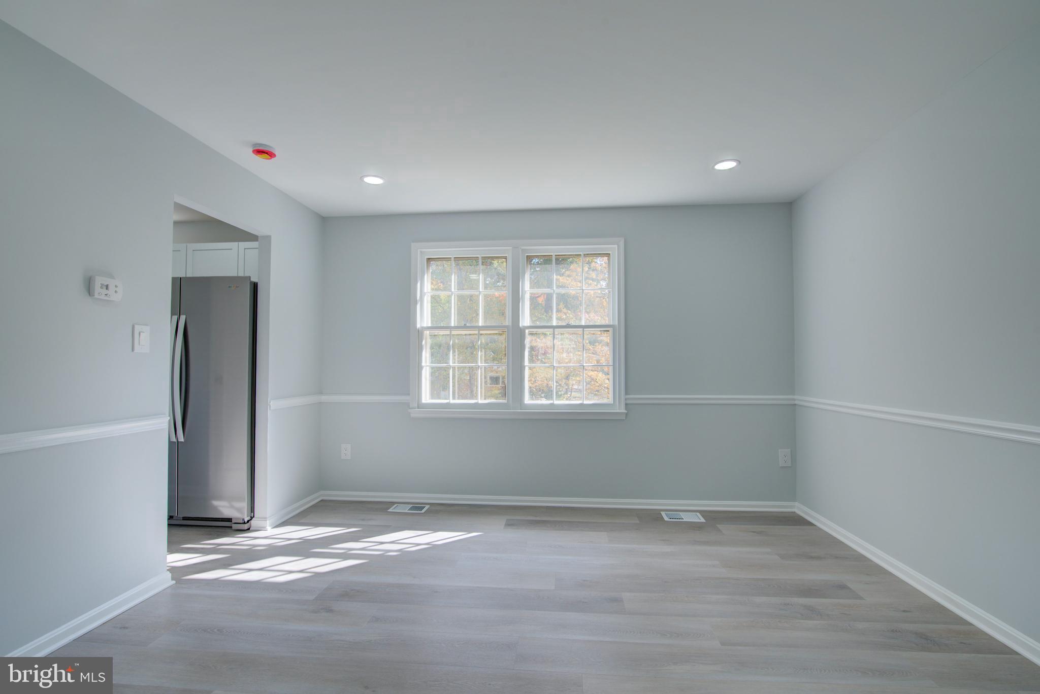 7411 Reservation Drive Springfield, VA 22153 - Photo 10 of 30 wooden floor in an empty room with a window