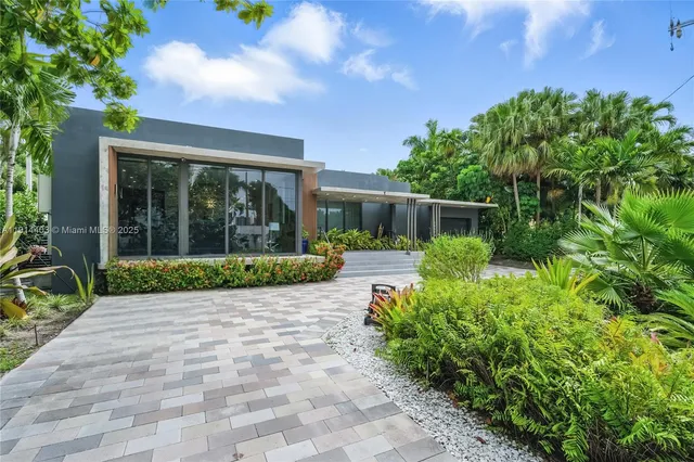 a view of a house with a backyard porch and sitting area