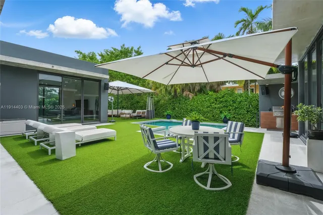 a view of yard with patio and outdoor seating