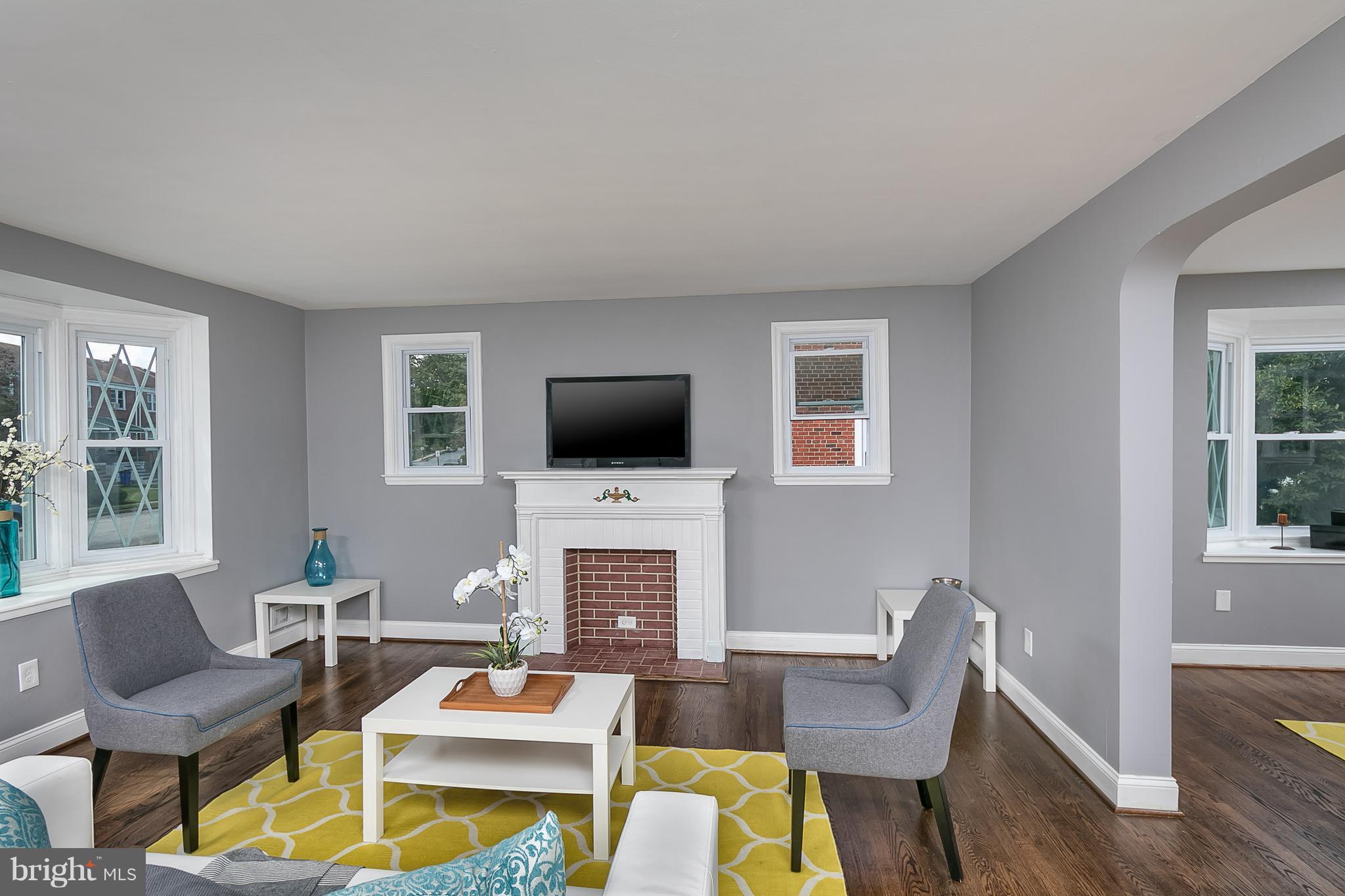 707 Stamford Road Baltimore, MD 21229 - Photo 13 of 30 a living room with furniture a flat screen tv and a fireplace