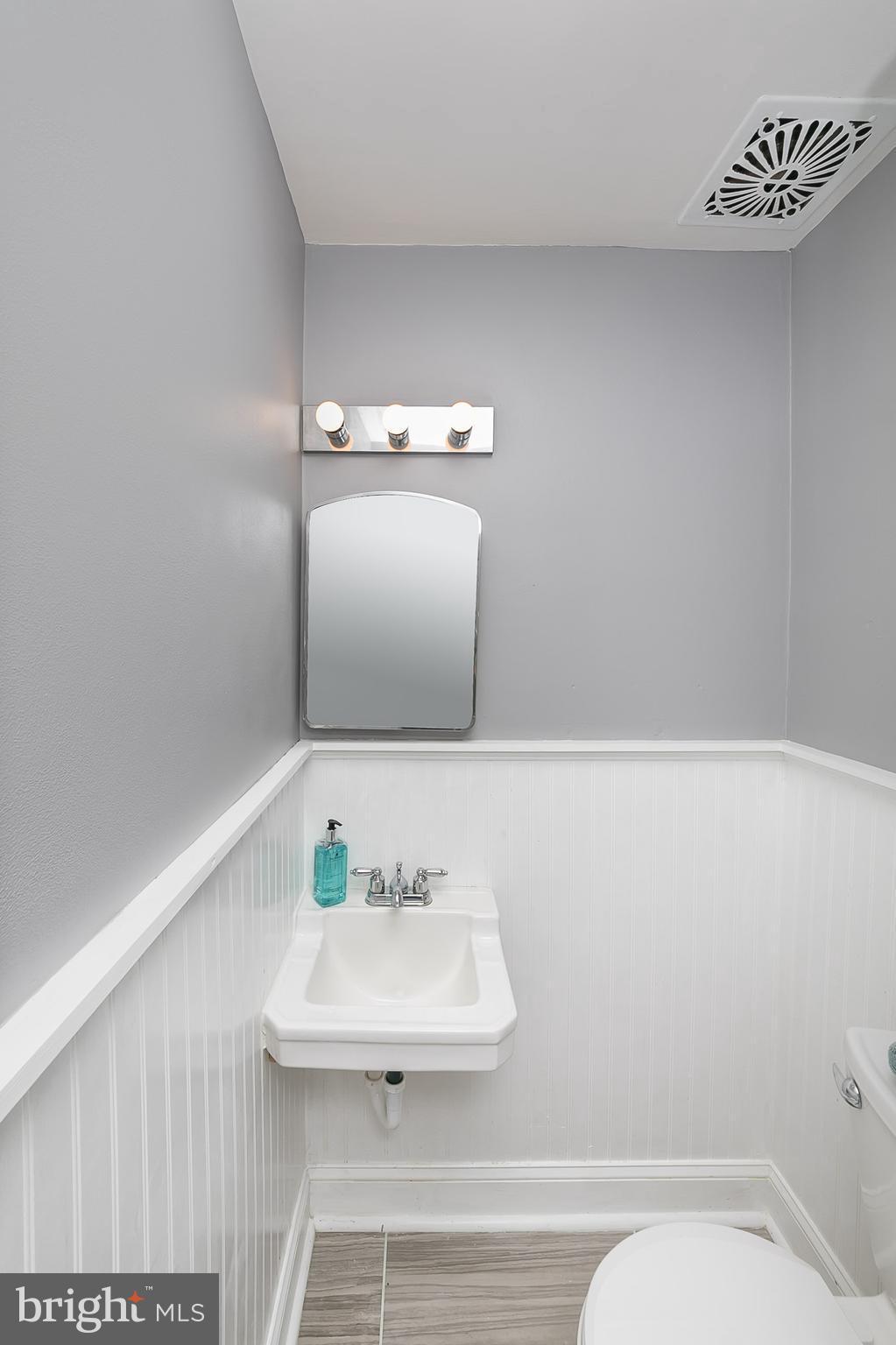 707 Stamford Road Baltimore, MD 21229 - Photo 15 of 30 a bathroom with a sink a toilet and a mirror