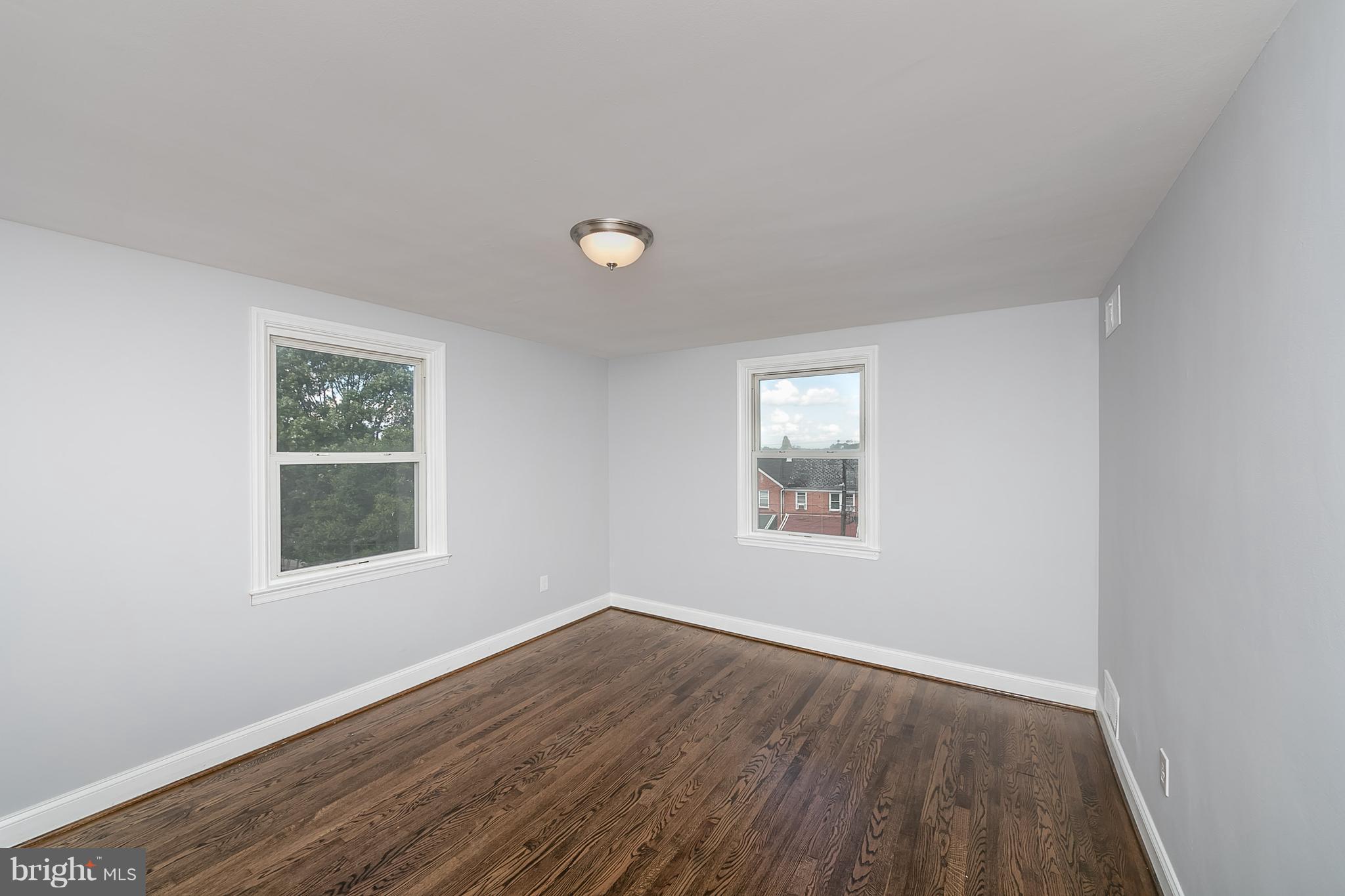 707 Stamford Road Baltimore, MD 21229 - Photo 18 of 30 an empty room with wooden floor and windows