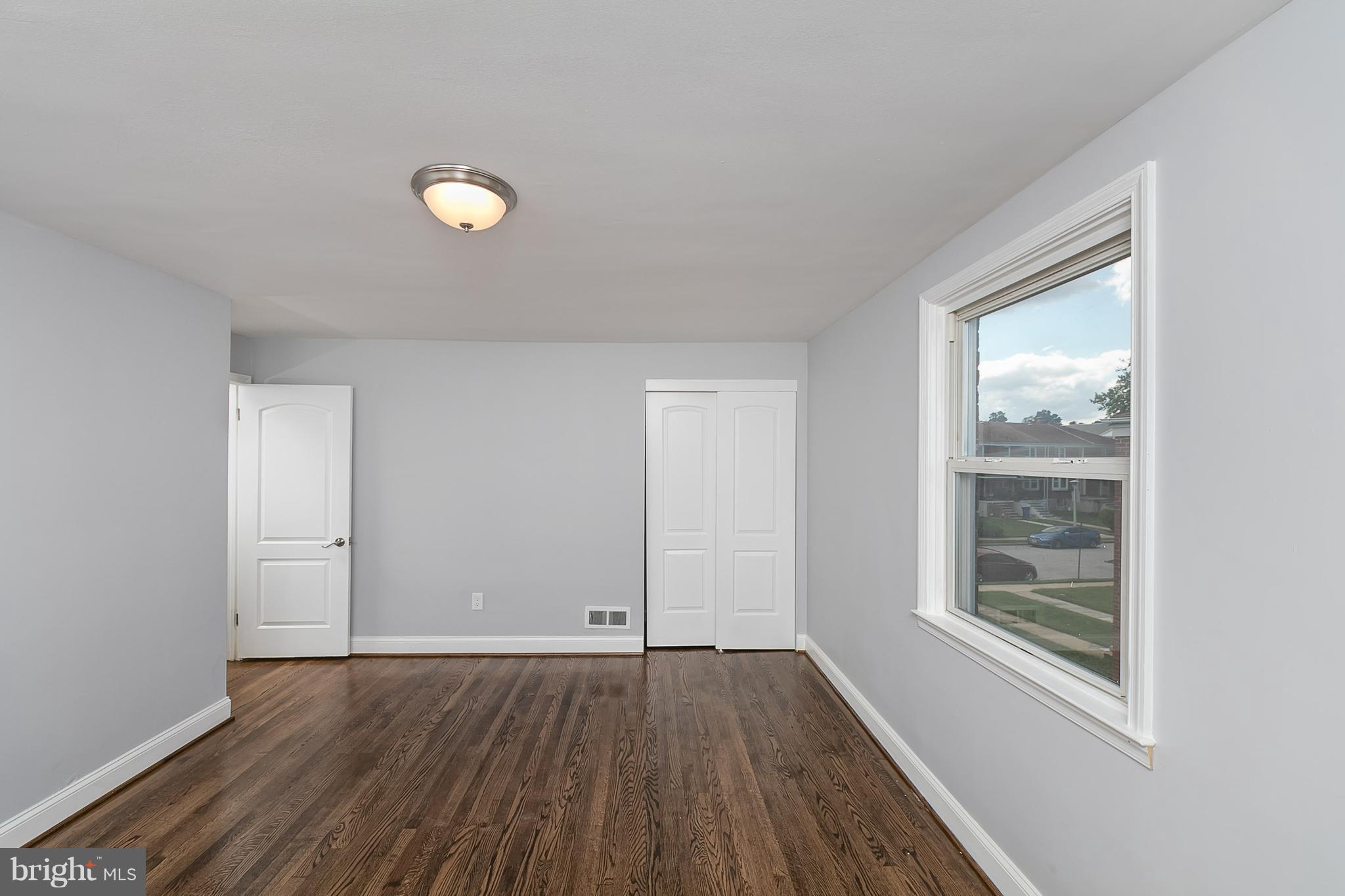 707 Stamford Road Baltimore, MD 21229 - Photo 19 of 30 an empty room with wooden floor and windows