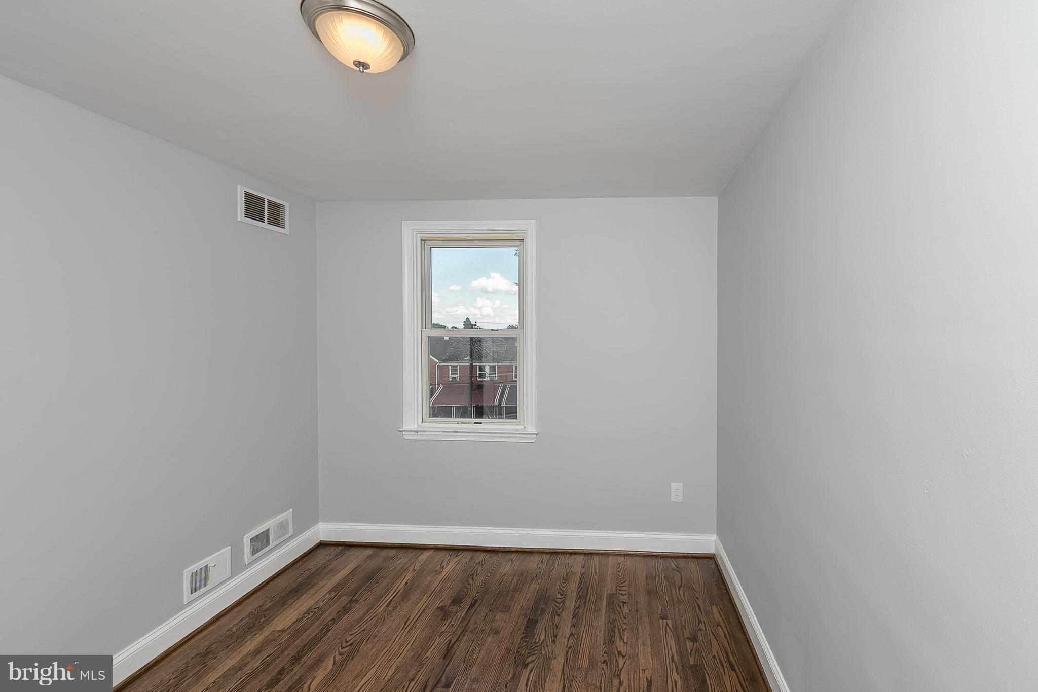 707 Stamford Road Baltimore, MD 21229 - Photo 20 of 30 an empty room with wooden floor and windows
