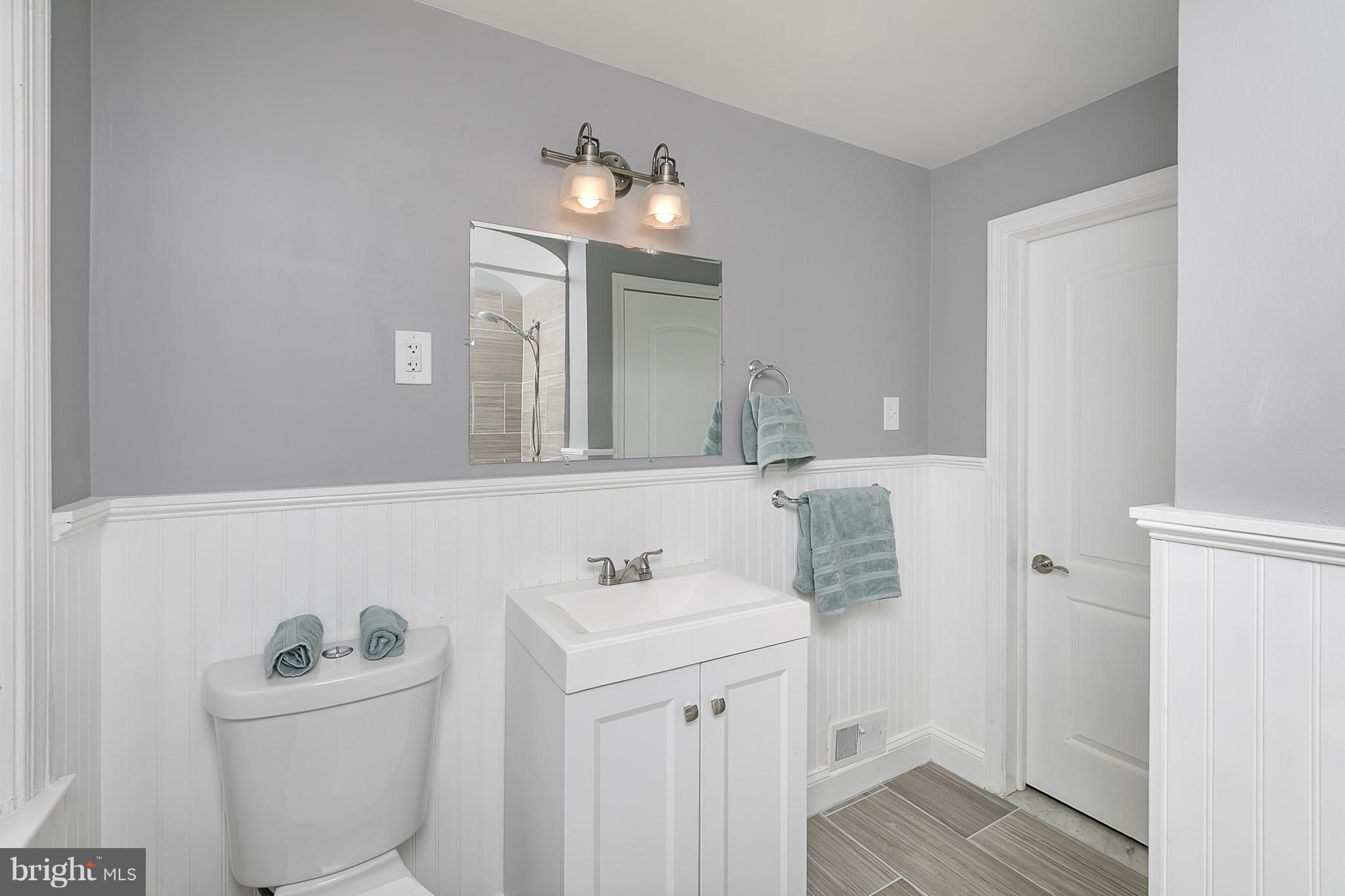 707 Stamford Road Baltimore, MD 21229 - Photo 22 of 30 a bathroom with a sink a toilet and mirror
