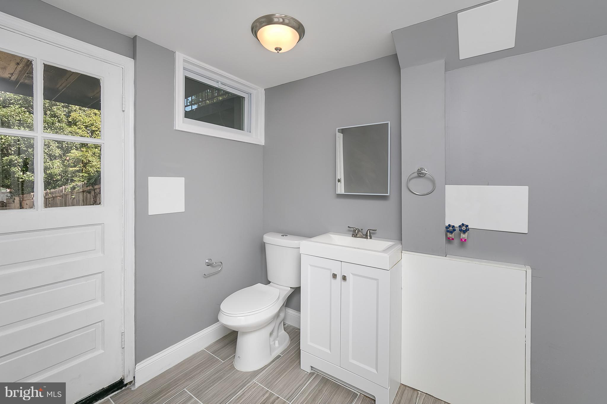 707 Stamford Road Baltimore, MD 21229 - Photo 26 of 30 a bathroom with a toilet sink and a window