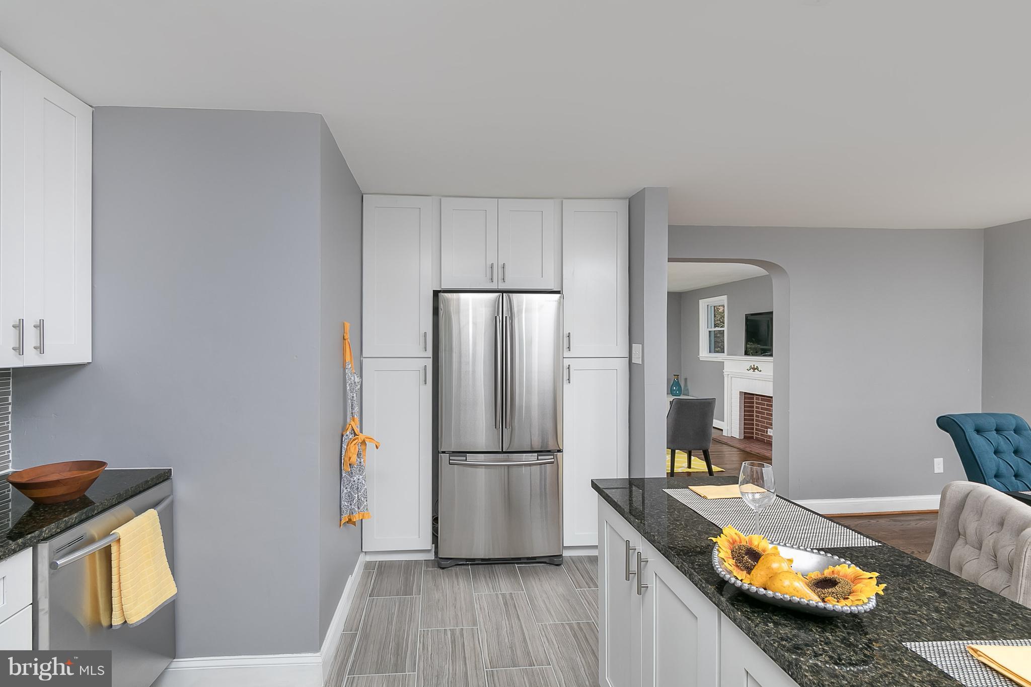 707 Stamford Road Baltimore, MD 21229 - Photo 6 of 30 a kitchen with refrigerator and wooden floor