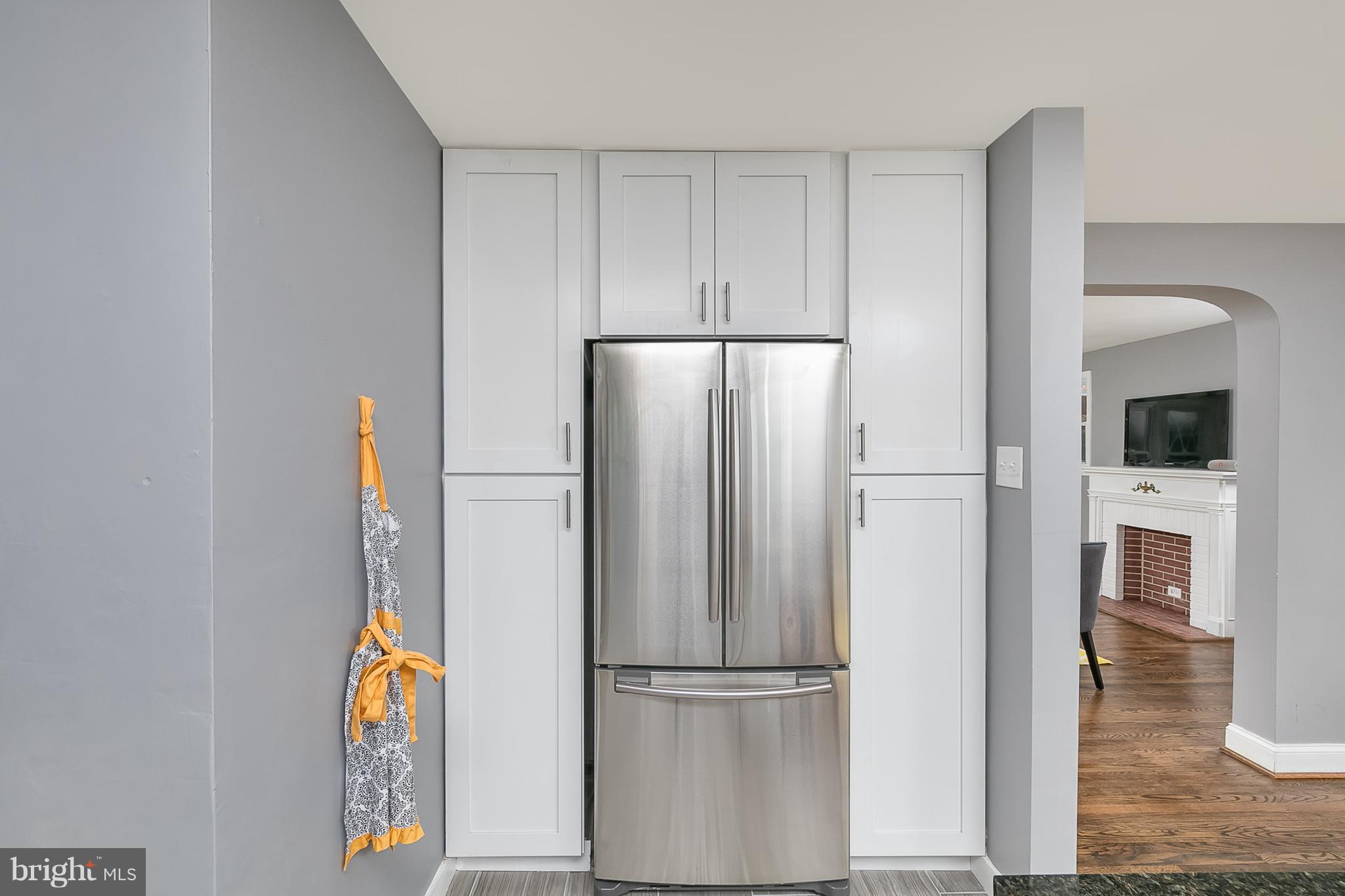 707 Stamford Road Baltimore, MD 21229 - Photo 7 of 30 a view of a refrigerator in kitchen and an empty room