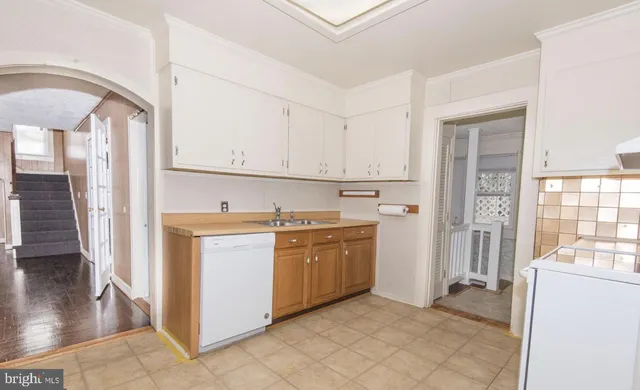 a kitchen with stainless steel appliances granite countertop a refrigerator and a stove