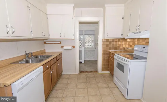 a kitchen with a sink stove and refrigerator