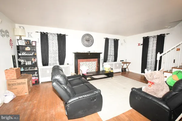 a living room with furniture window and wooden floor