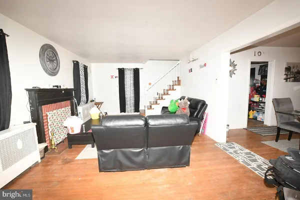a living room with furniture a clock and a window