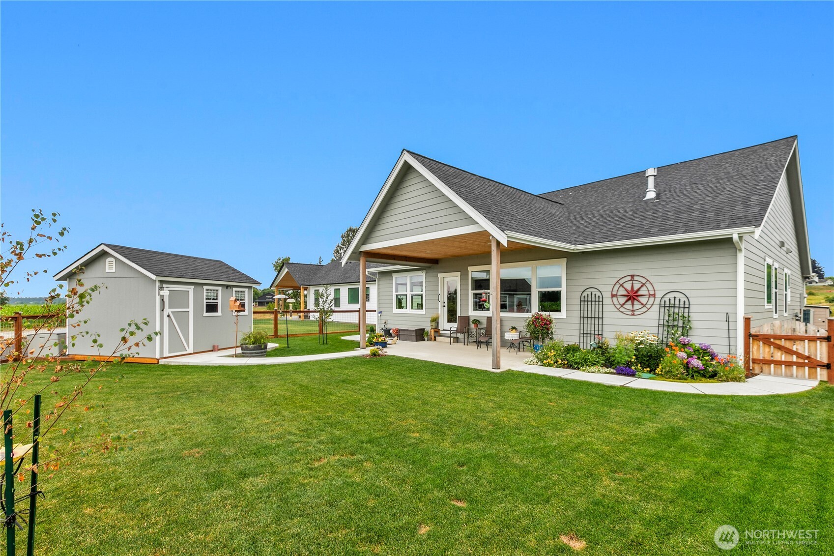 2068 Bowfin Way Lynden, WA 98264 - Photo 28 of 35 a front view of a house with a garden and trees