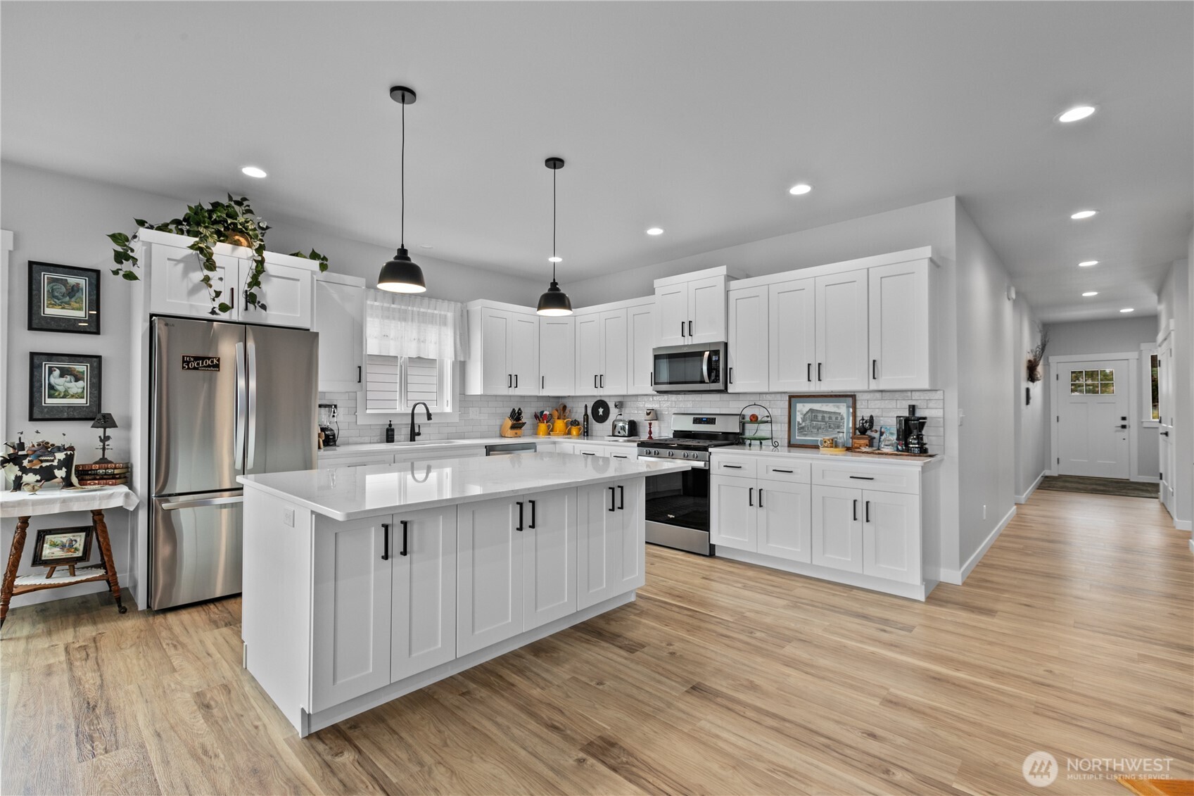 2068 Bowfin Way Lynden, WA 98264 - Photo 6 of 35 a large kitchen with stainless steel appliances and white cabinets