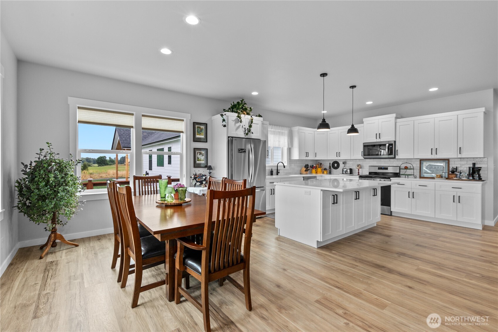 2068 Bowfin Way Lynden, WA 98264 - Photo 7 of 35 a kitchen with granite countertop stainless steel appliances refrigerator dining table and chairs