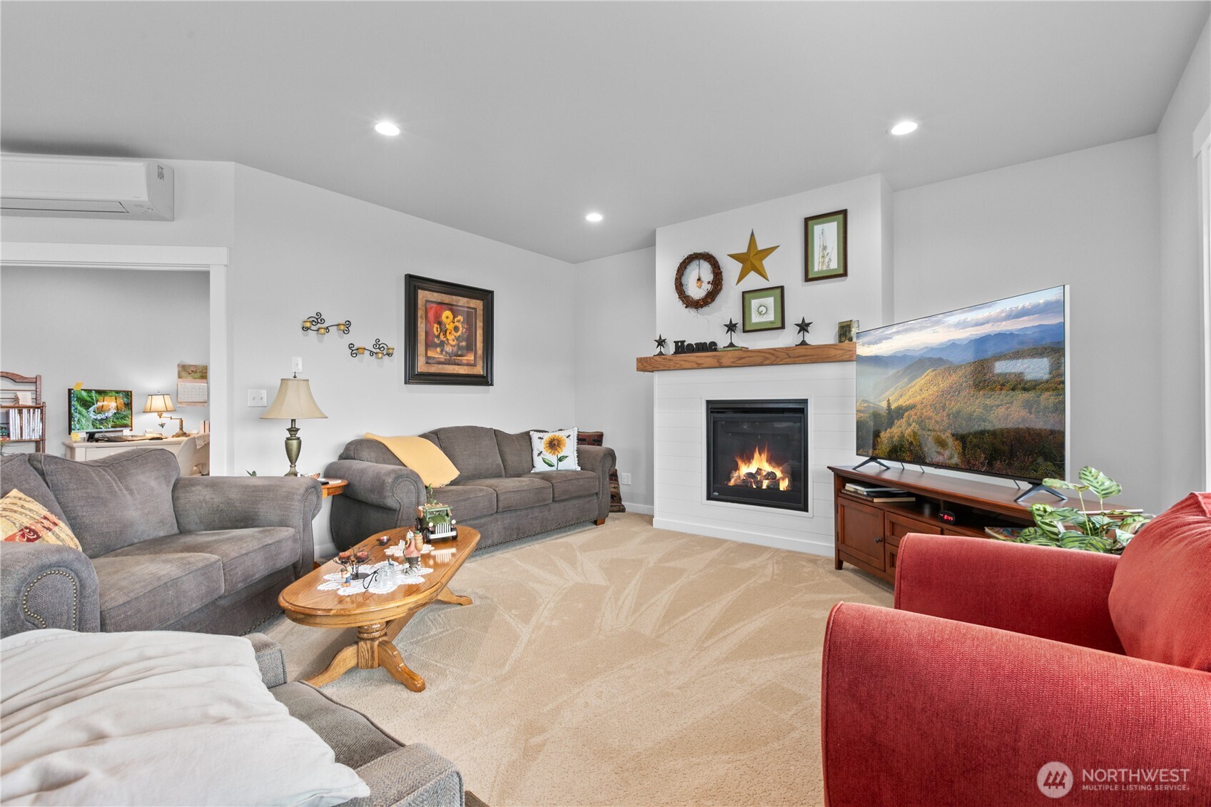 2068 Bowfin Way Lynden, WA 98264 - Photo 10 of 35 a living room with furniture a flat screen tv and a fireplace