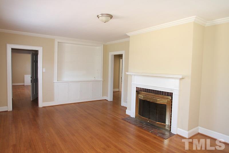 810 Chamberlain Street Raleigh, NC 27607 - Photo 4 of 16 a view of a livingroom with wooden floor and a fireplace