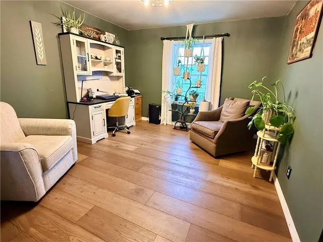 a kitchen with stainless steel appliances granite countertop a refrigerator a stove a sink dishwasher a microwave oven with white cabinets and wooden floor