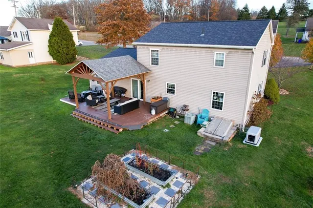a view of a house with backyard and sitting area