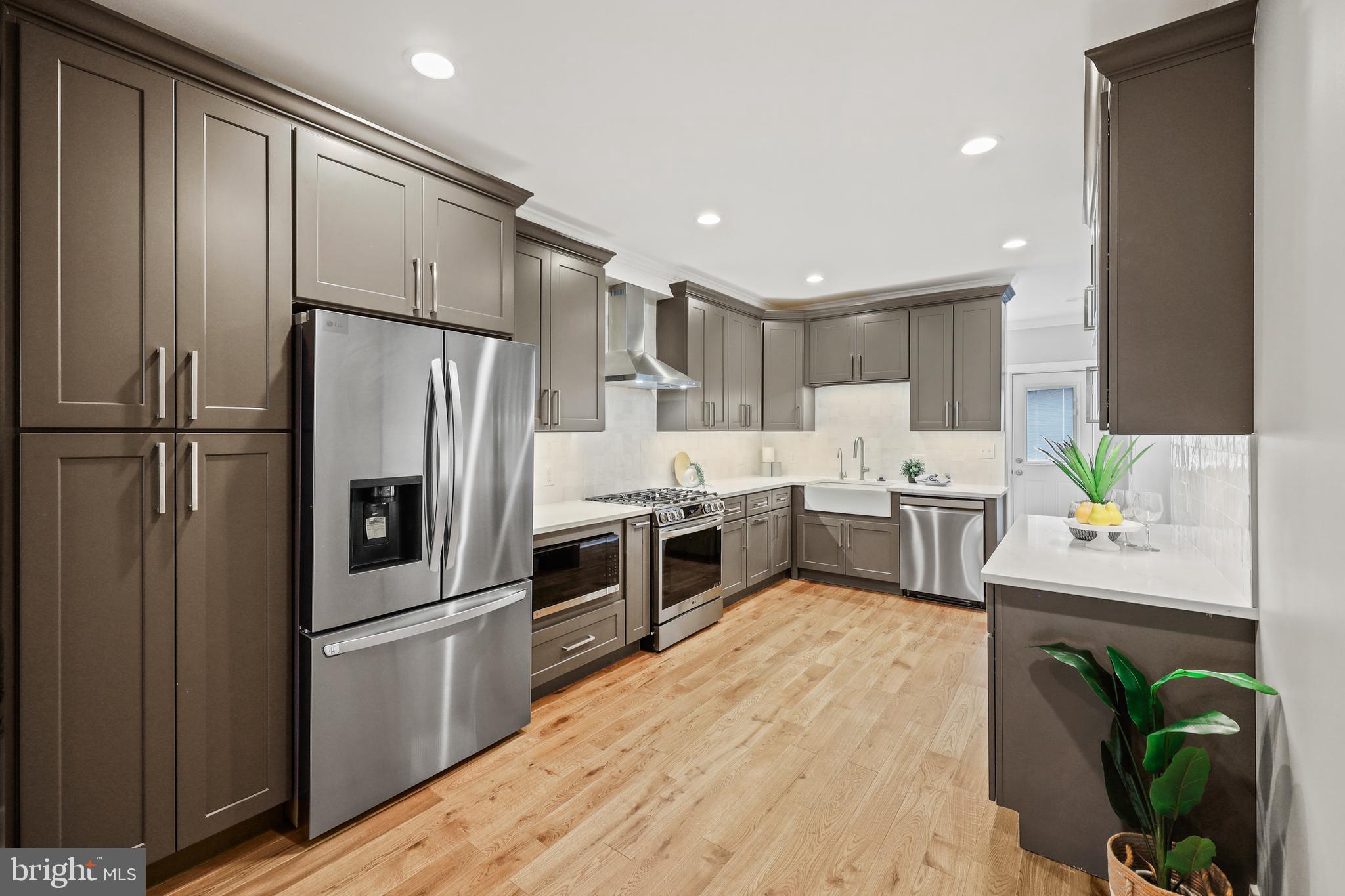 1465 Towson Street Baltimore, MD 21230 - Photo 1 of 39 a kitchen with stainless steel appliances a refrigerator sink and white cabinets