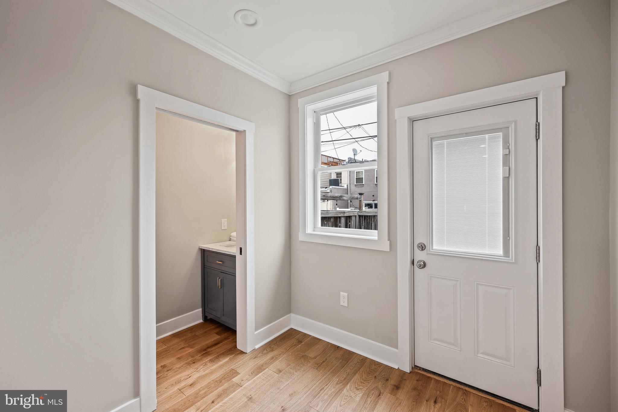 1465 Towson Street Baltimore, MD 21230 - Photo 13 of 39 an empty room with wooden floor cabinet and windows