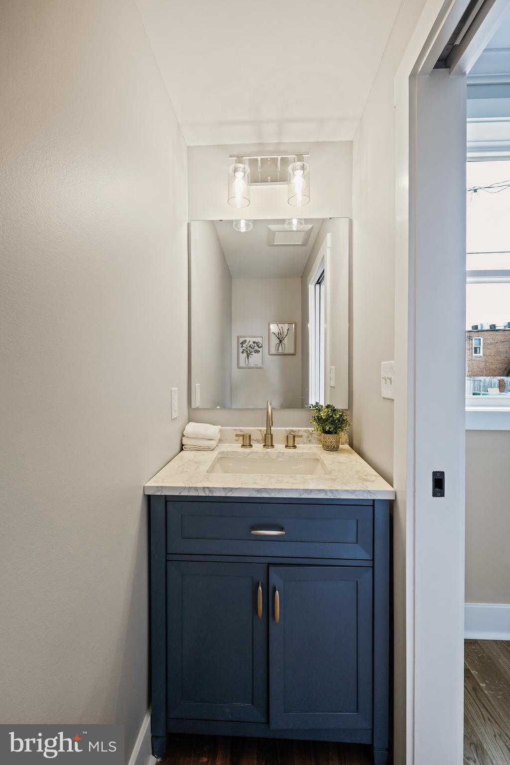 1465 Towson Street Baltimore, MD 21230 - Photo 16 of 39 a bathroom with a sink and a mirror