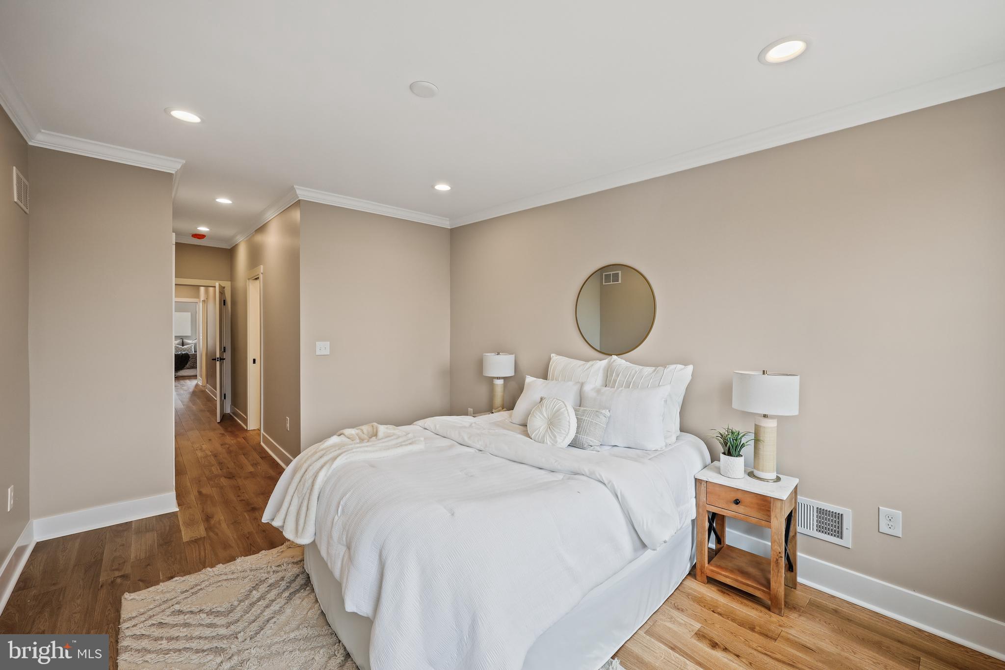1465 Towson Street Baltimore, MD 21230 - Photo 17 of 39 a bedroom with a bed and wooden floor