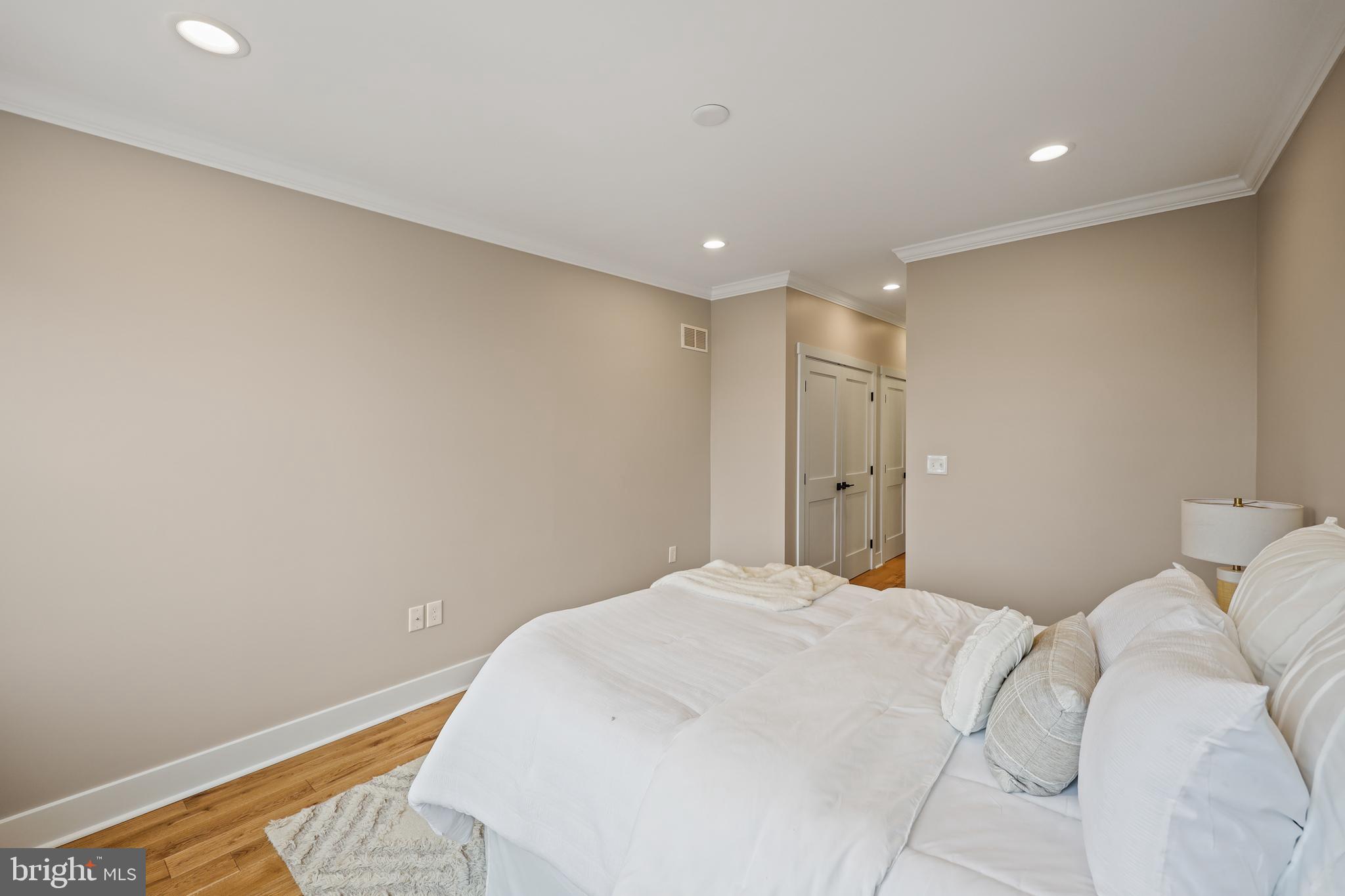1465 Towson Street Baltimore, MD 21230 - Photo 18 of 39 a large white bed in a white room