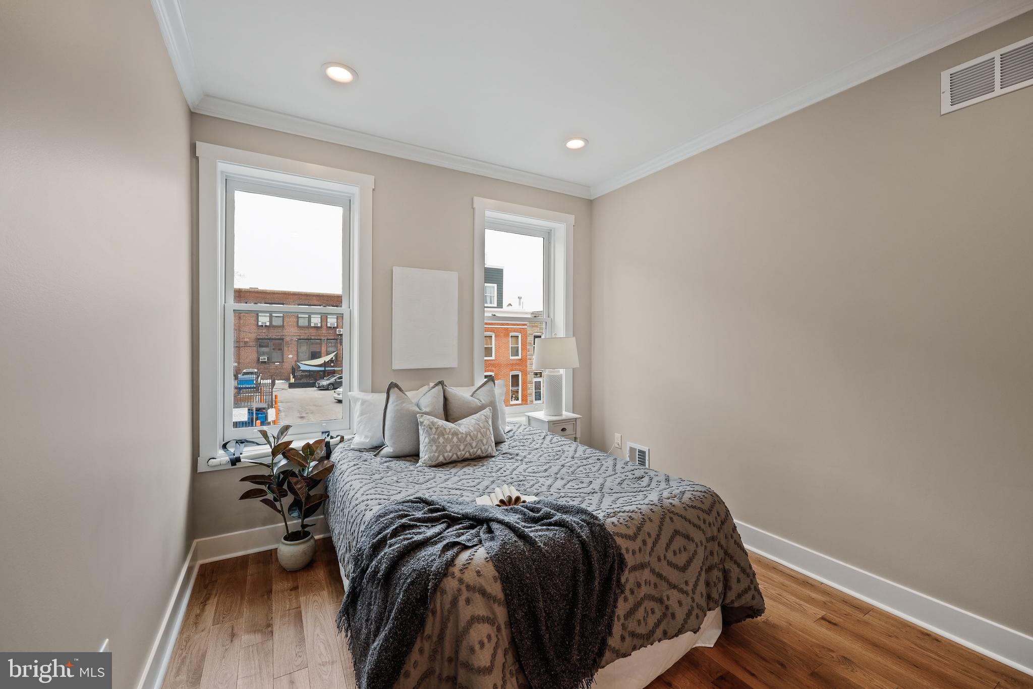 1465 Towson Street Baltimore, MD 21230 - Photo 21 of 39 a bedroom with a bed and wooden floor