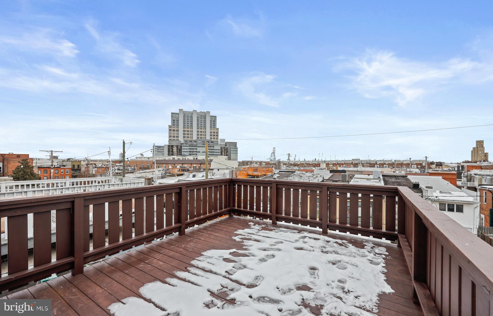 1465 Towson Street Baltimore, MD 21230 - Photo 26 of 39 a view of a roof deck with wooden fence