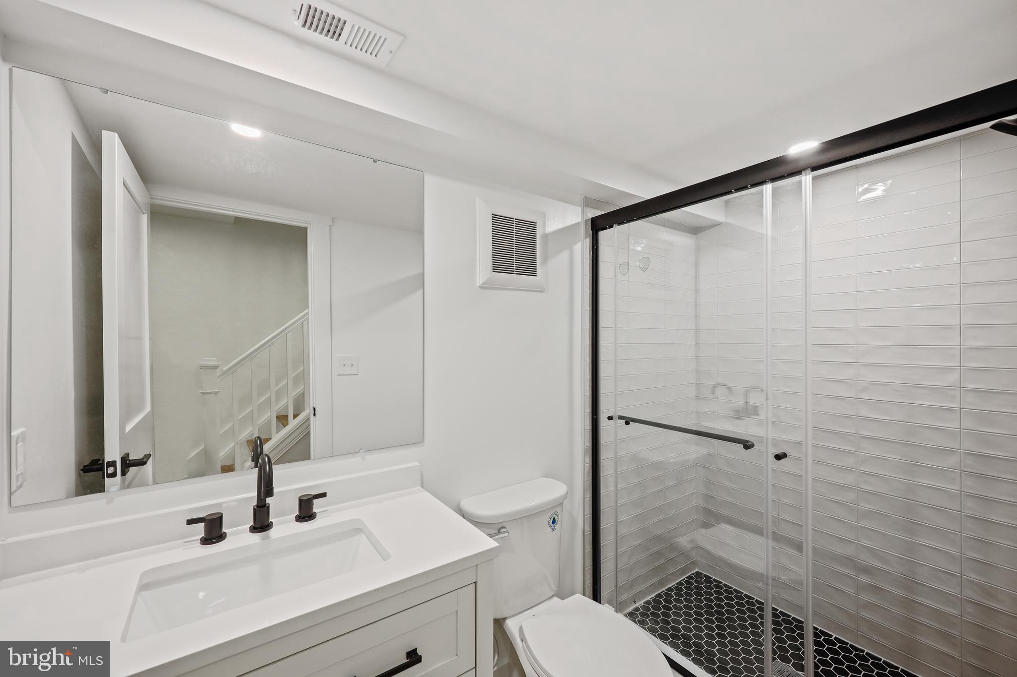 1465 Towson Street Baltimore, MD 21230 - Photo 31 of 39 a bathroom with a sink toilet and shower