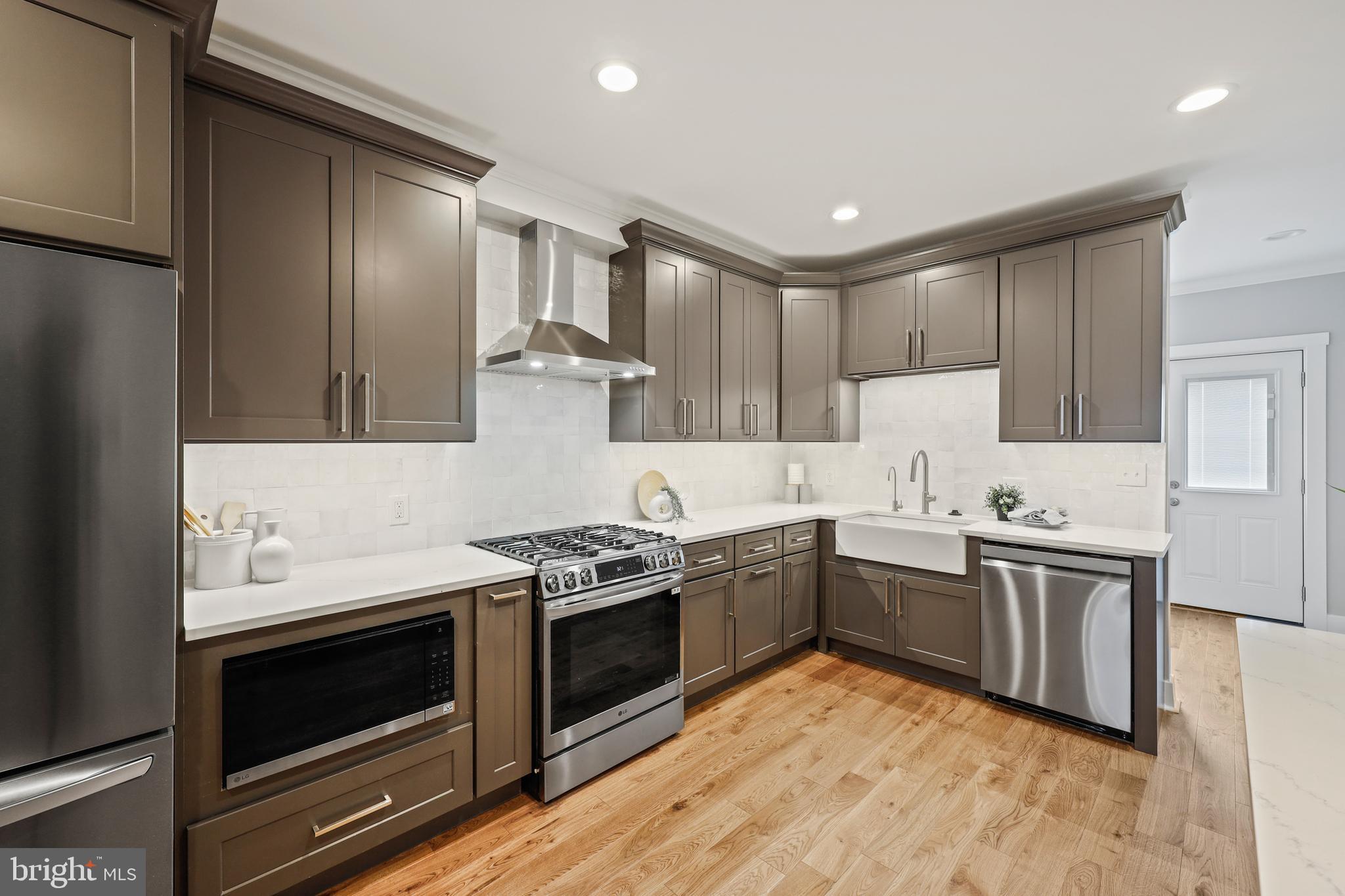 1465 Towson Street Baltimore, MD 21230 - Photo 8 of 39 a kitchen with stainless steel appliances granite countertop a stove sink and cabinets